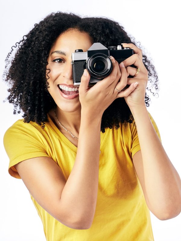 Photography, camera and happy woman photographer and happy as a creative isolated in a studio white.