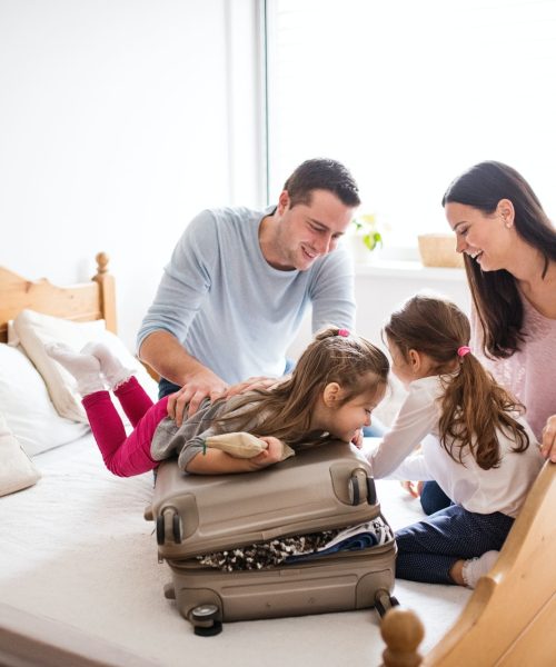 young-family-with-two-children-packing-for-holiday-